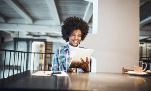Casual woman, African-American Ethnicity, using digital tablet in high end restaurant